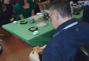 Closely inspecting a single brewed oolong tea leaf