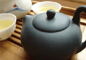 blue purple clay pot on bamboo tea tray
